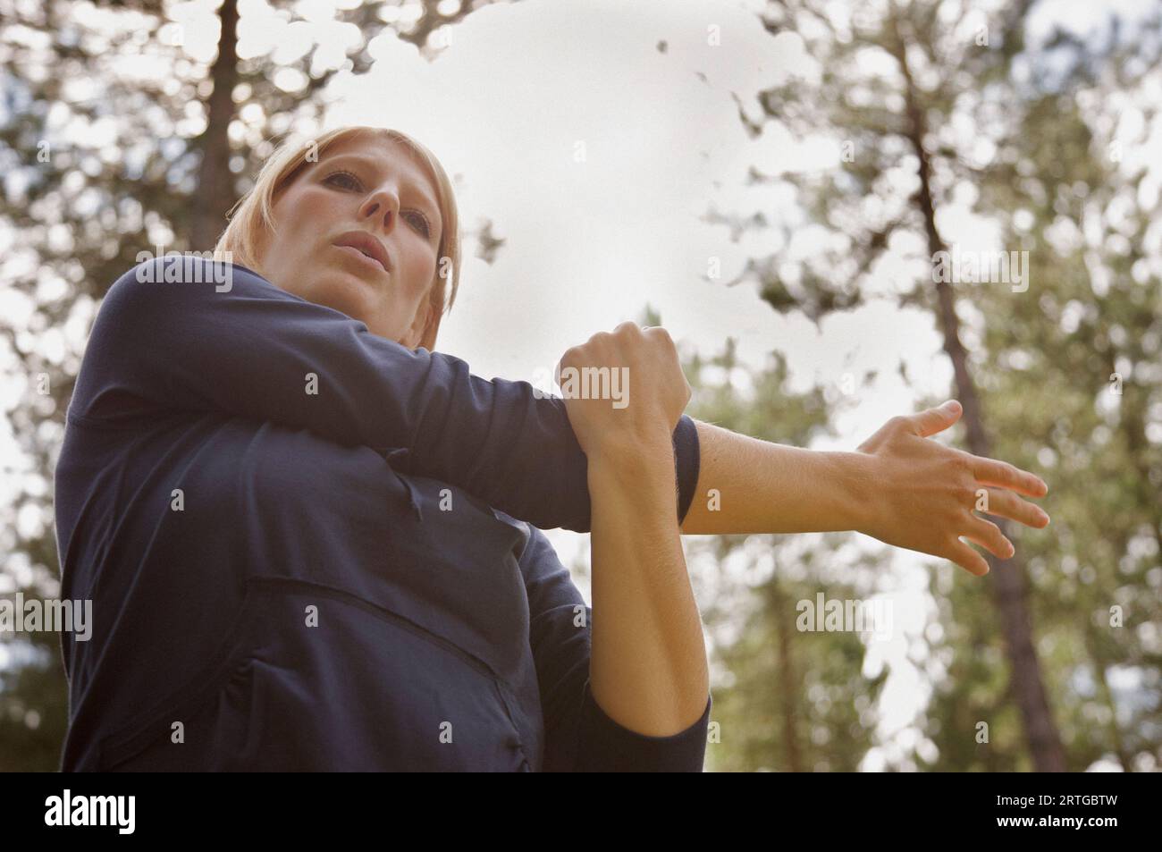 Young woman standing in a forest étend son bras Banque D'Images