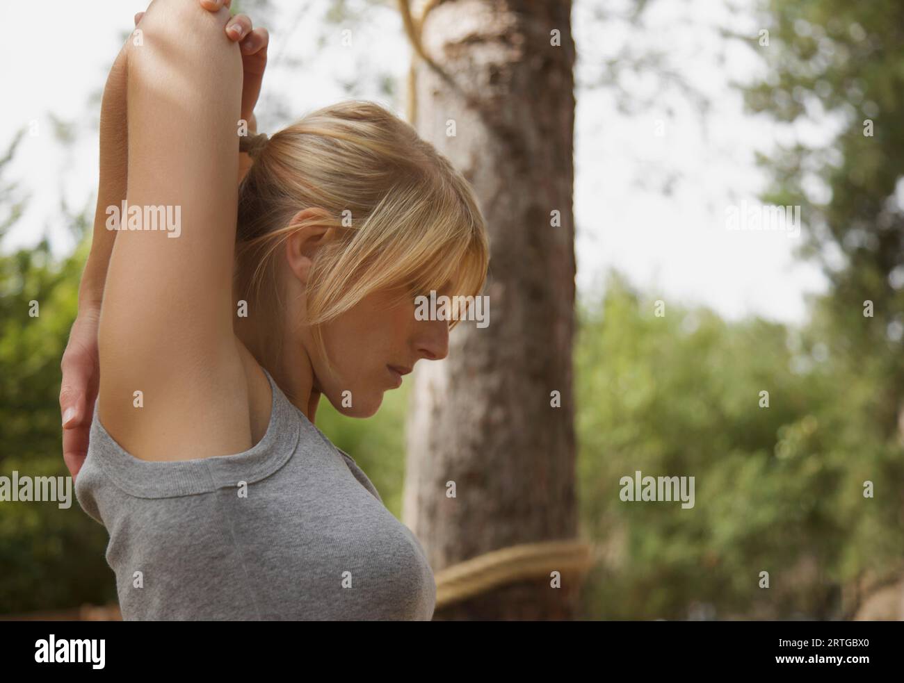 Young woman standing in a forest étend son bras Banque D'Images