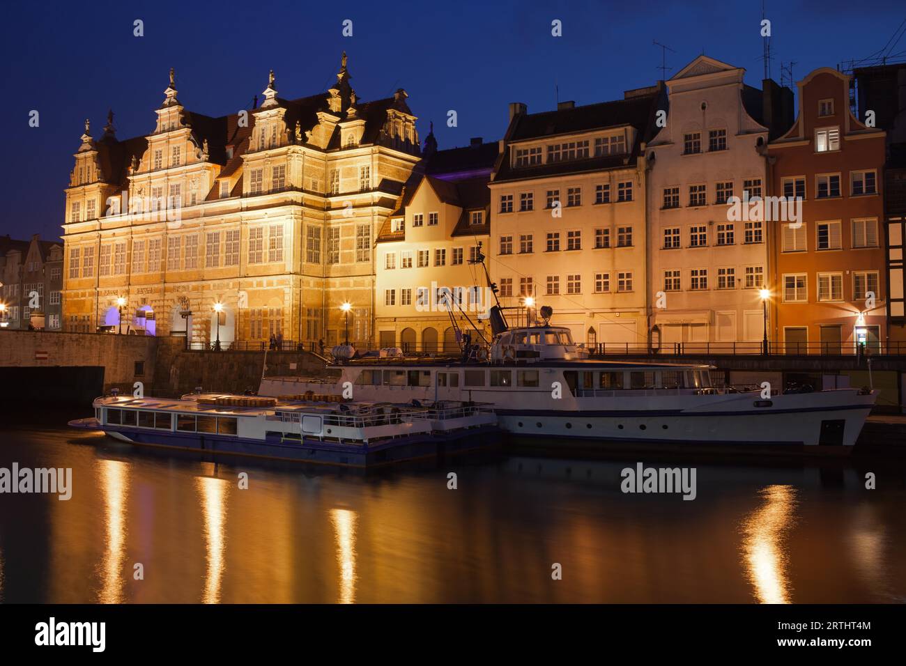 Ville de Gdansk par nuit en Pologne, porte verte et les maisons historiques, les bateaux de passagers sur la rivière Motlawa Banque D'Images