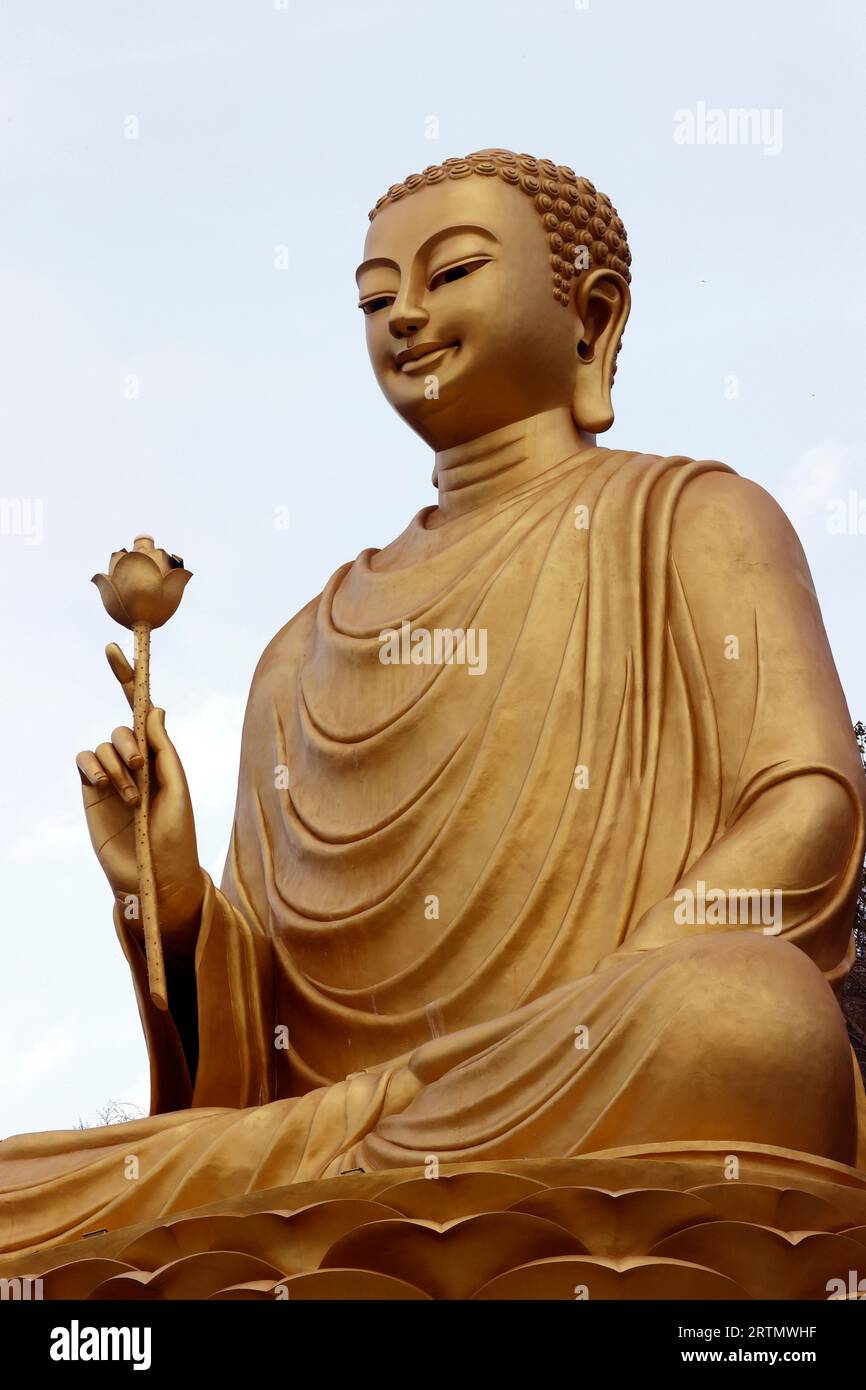 Statue de Bouddha d'or avec fleur de lotus à la main. Vung Tau. Vietnam. Banque D'Images Statue de Bouddha d'or avec fleur de lotus à la main. Vung Tau. Vietnam. Banque D'Images