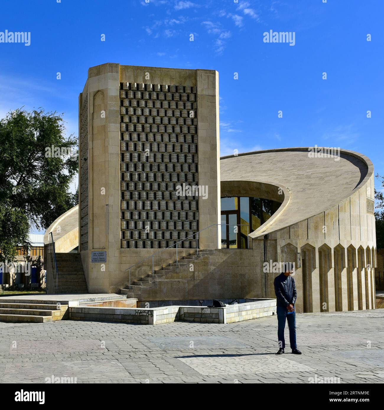 Local debout devant le mémorial à l'Imam Ismail al-Bukhari, un monument brutaliste / socialiste moderniste à Boukhara, Ouzbékistan Banque D'Images
