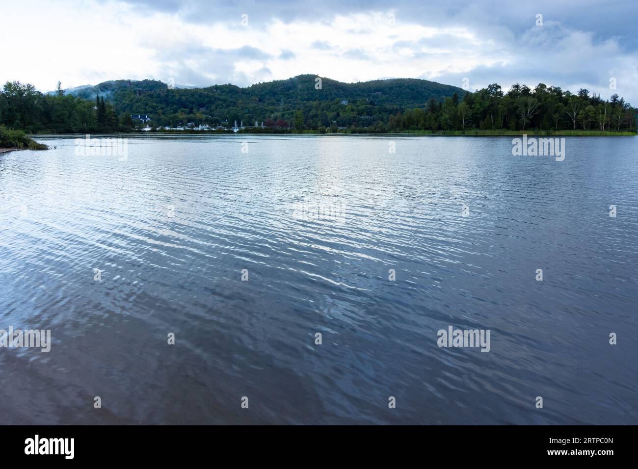 Les eaux céruléennes semblent fondues sur le lac placide dans le pays des chalets d'été Banque D'Images