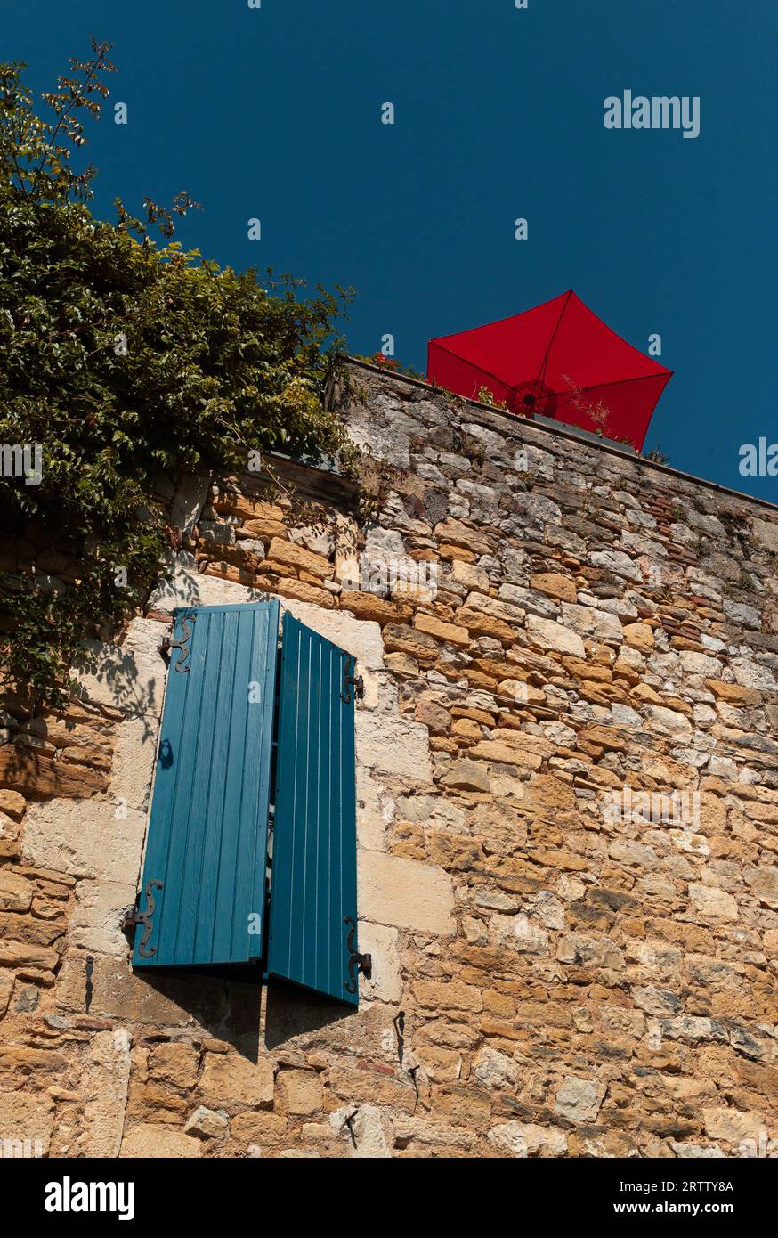 Tour et parasol rouge rue de la cale, Puy-l'Évêque, Lot, France Banque D'Images