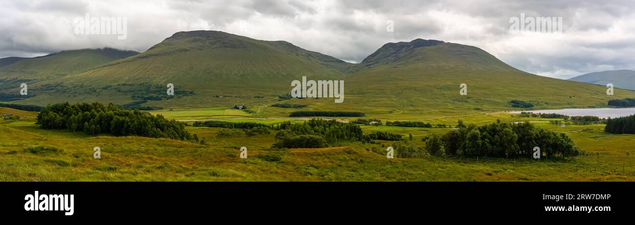 Grand panorama sur le paysage montagneux et verdoyant avec les lacs de la vallée de Glencoe, en Écosse. Banque D'Images
