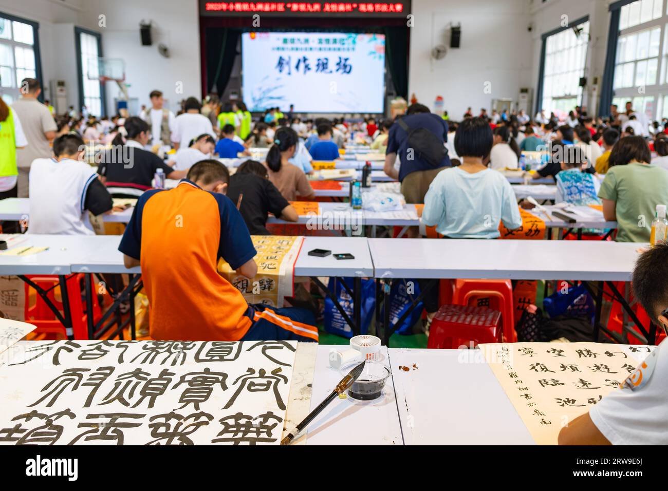 Zhongshan Chine-juillet 13,2020:étudiants en compétition de calligraphie utilisant des pinceaux chinois à la composition horizontale. Banque D'Images