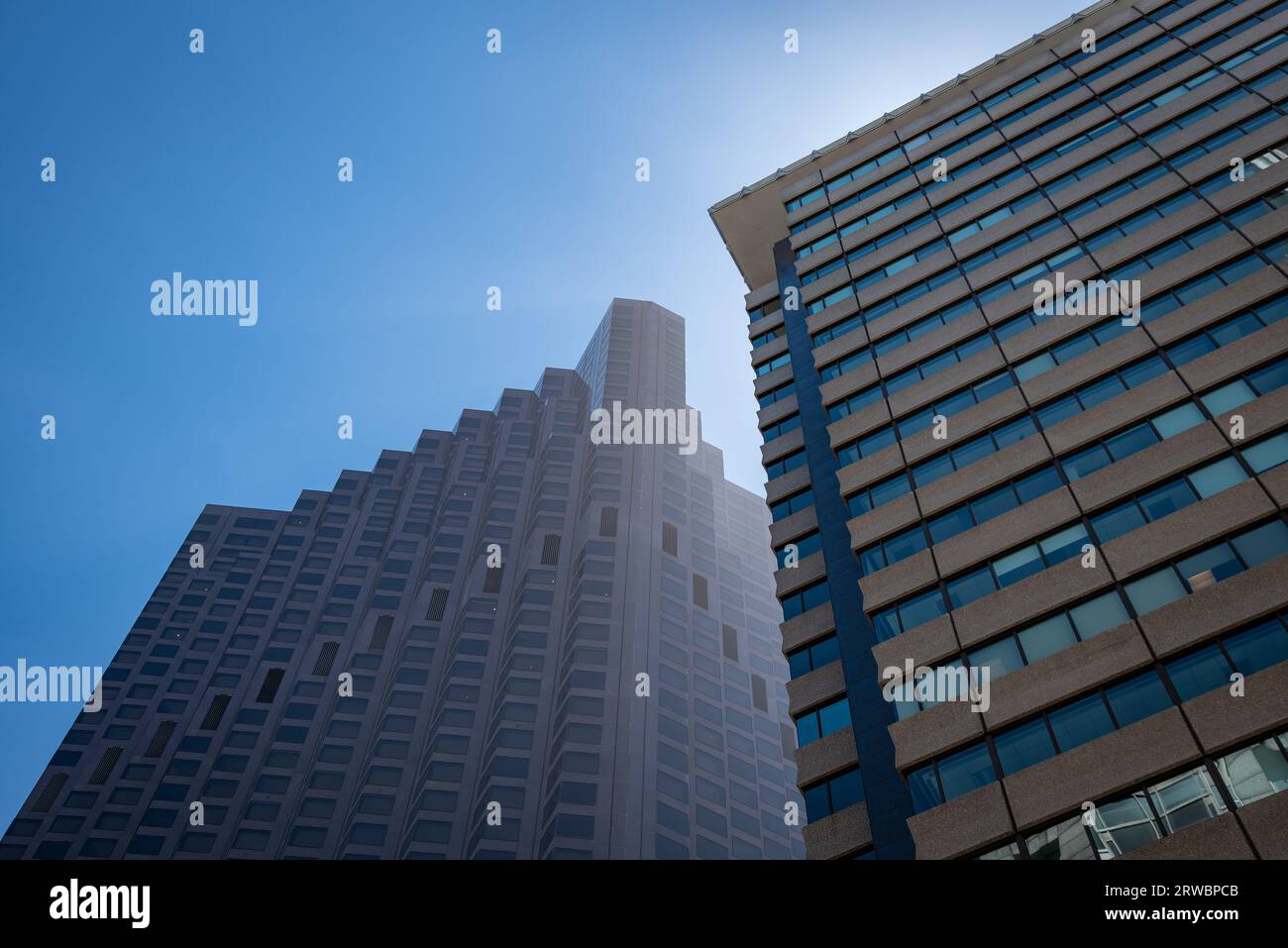 Bloc de tour d'affaires de riser élevé avec fond de ciel bleu et soleil Banque D'Images