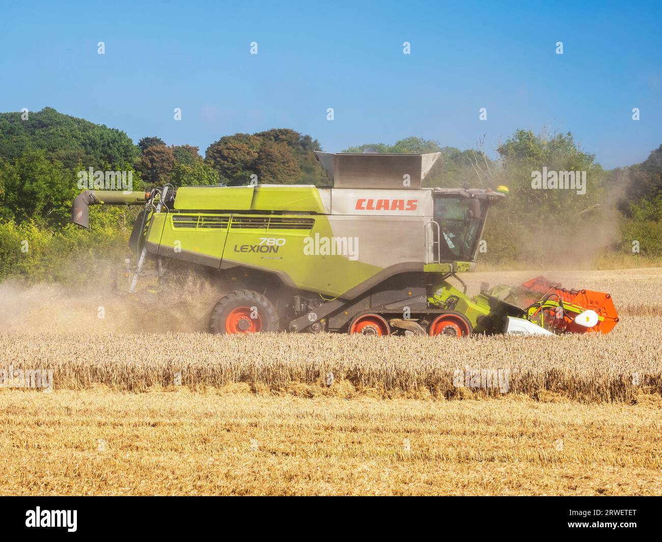 Un agriculteur récoltant un champ de blé à Cley Next the Sea, Norfolk, Royaume-Uni. Banque D'Images