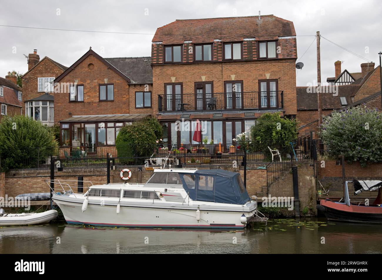 Propriétés modernes au bord de la rivière avec amarrages de bateaux privés le long de Tewkesbury Royaume-Uni Banque D'Images