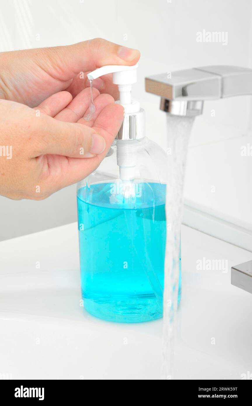 Retrait du savon liquide d'un distributeur de savon Banque D'Images