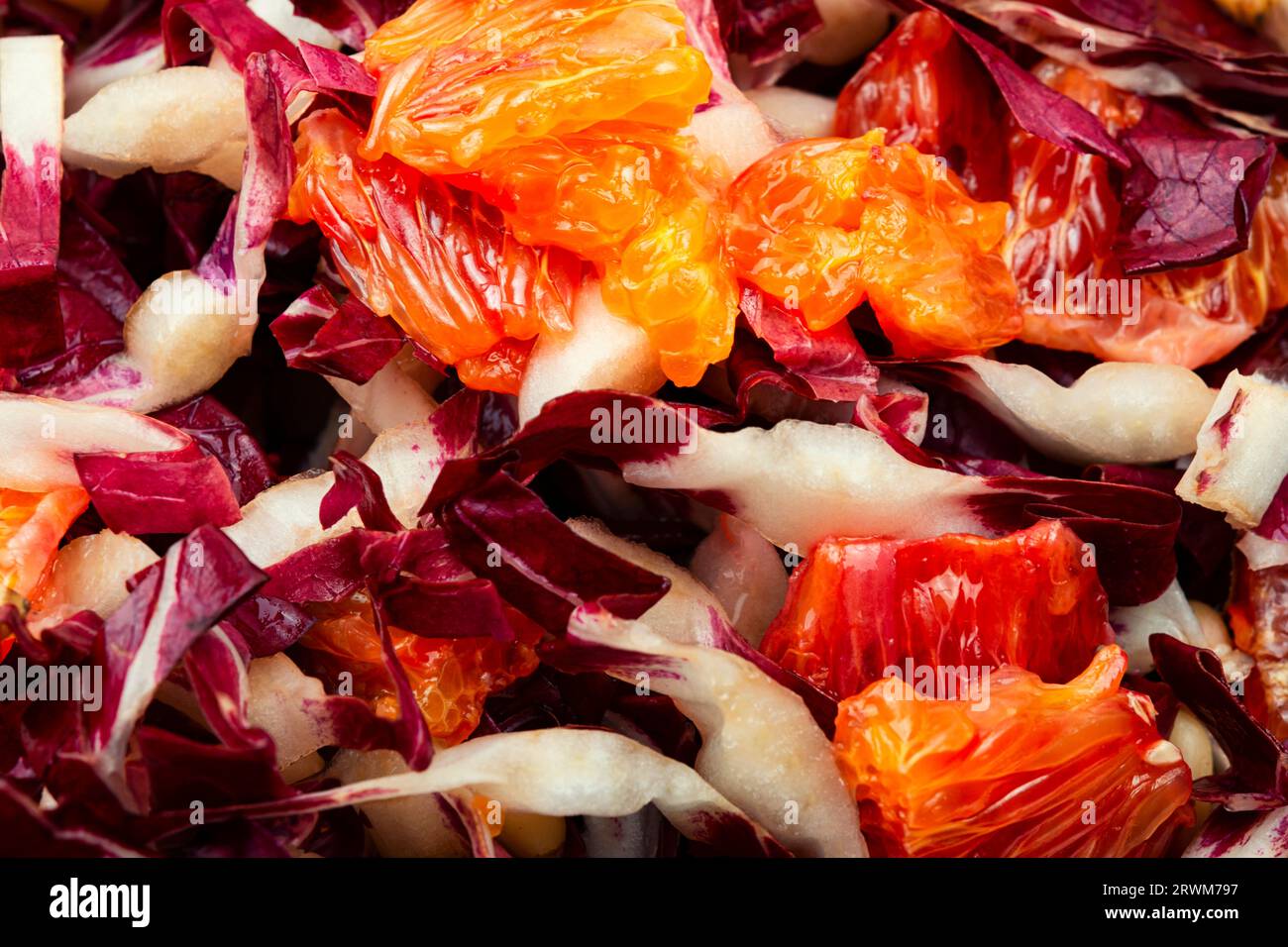 Salade de légumes avec chicorée rouge, pamplemousse et pignons de pin sur une assiette. La nourriture Banque D'Images