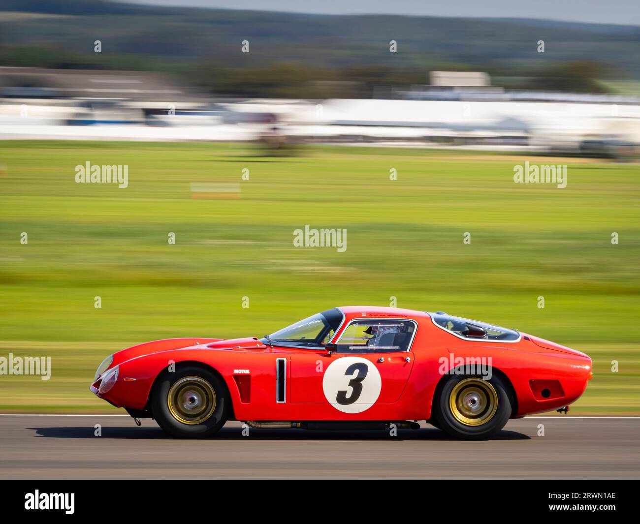 Une voiture de course rouge Bizzarrini 5300GT dans la course de voitures classiques Royal automobile Club TT Celebration 2023 au Goodwood Revival, West Sussex UK Banque D'Images