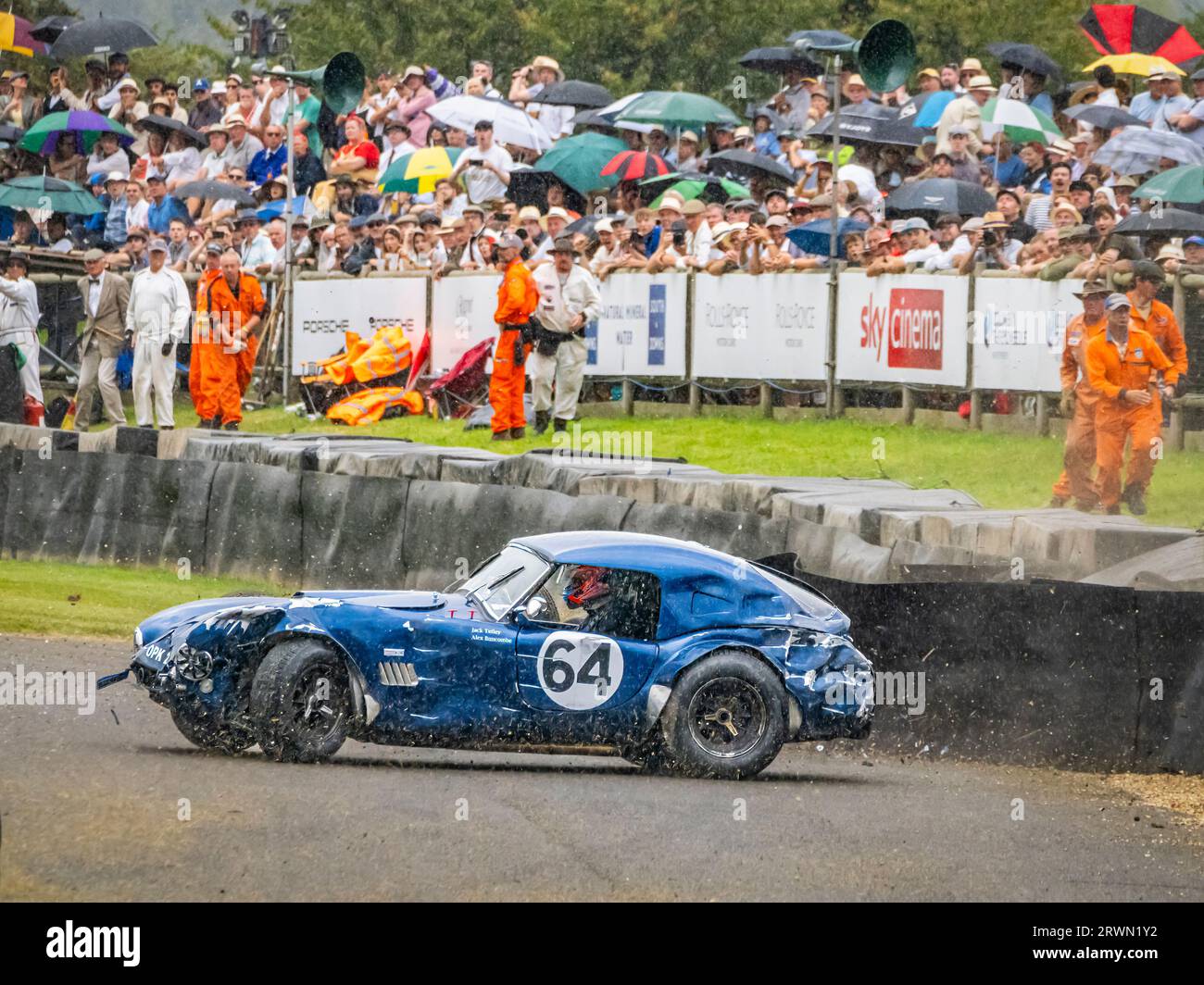 Un Cobra s'écrase sous la pluie à Madgewick dans la course de voitures classiques Royal automobile Club TT Celebration 2023 au Goodwood Revival, West Sussex UK Banque D'Images