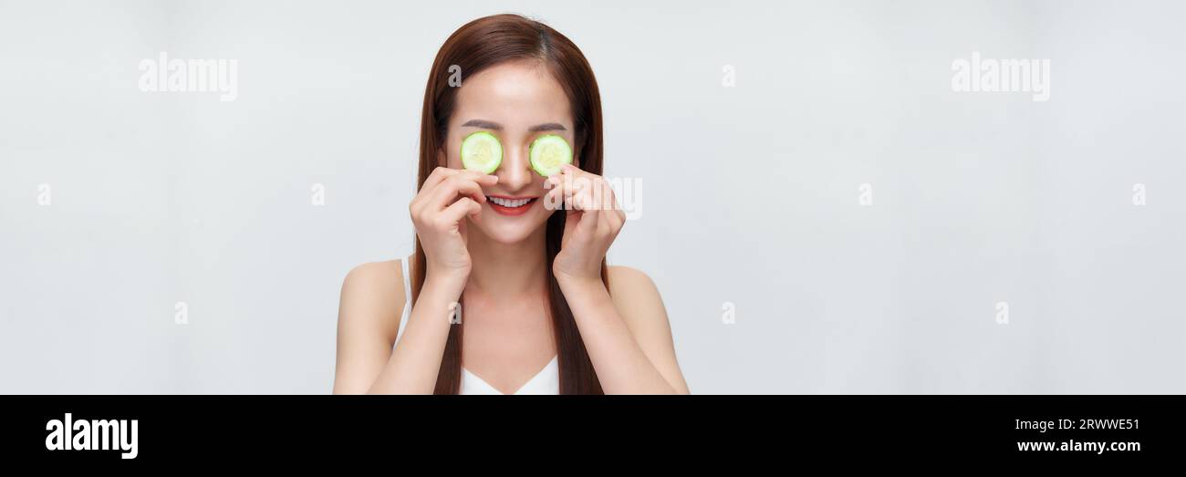 Bannière de femme avec des tranches de concombre sur ses yeux Banque D'Images