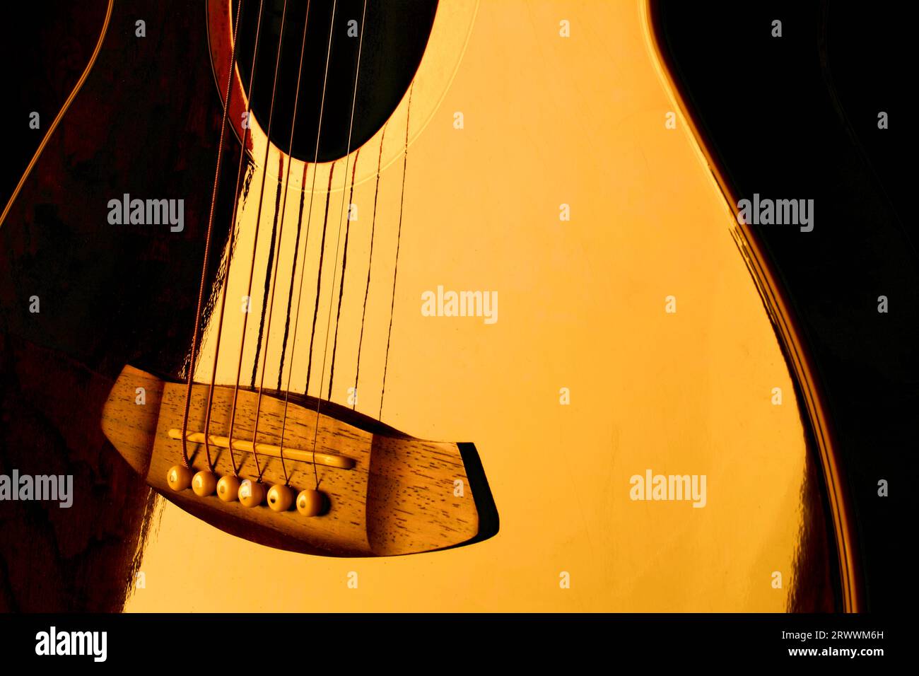 Le corps d'une guitare électrique réfléchissant la lumière dorée. Banque D'Images