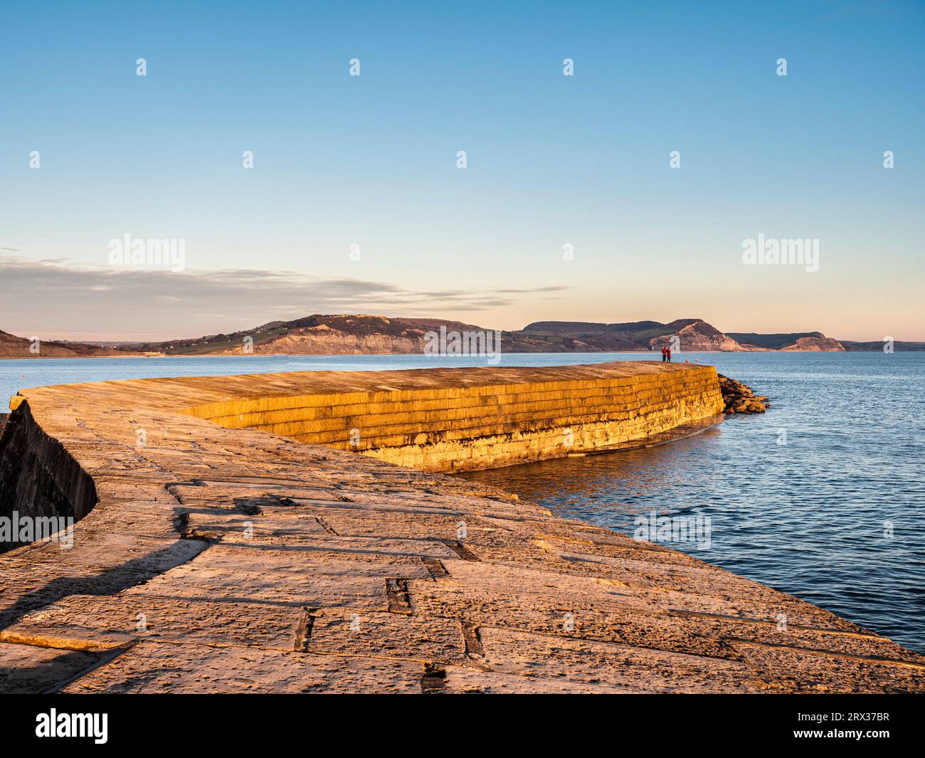 Les gens à la fin du Cobb appréciant la lumière du soir, Lyme Regis, Dorset, Angleterre, Royaume-Uni, Europe Banque D'Images
