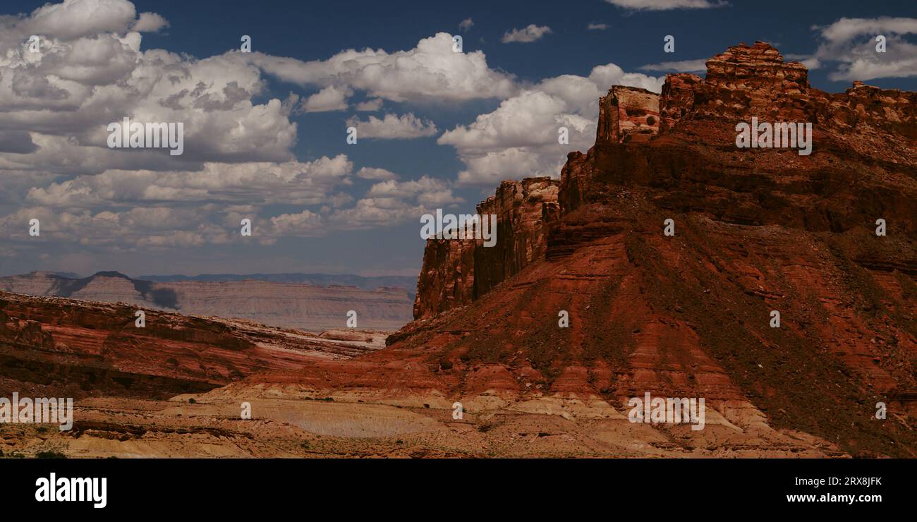 Des nuages fantaisistes et rêveurs flottent au-dessus du Black Dragon Canyon à San Rafael Swell, Utah, par une journée d'été idyllique. Banque D'Images