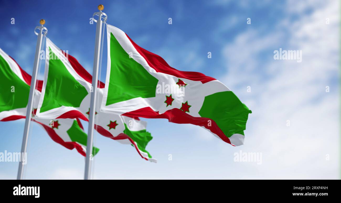 Drapeaux nationaux du Burundi brandissant par temps clair. Croix diagonale blanche se divisant en sections rouge et verte, trois étoiles vertes au centre. 3d illust Banque D'Images