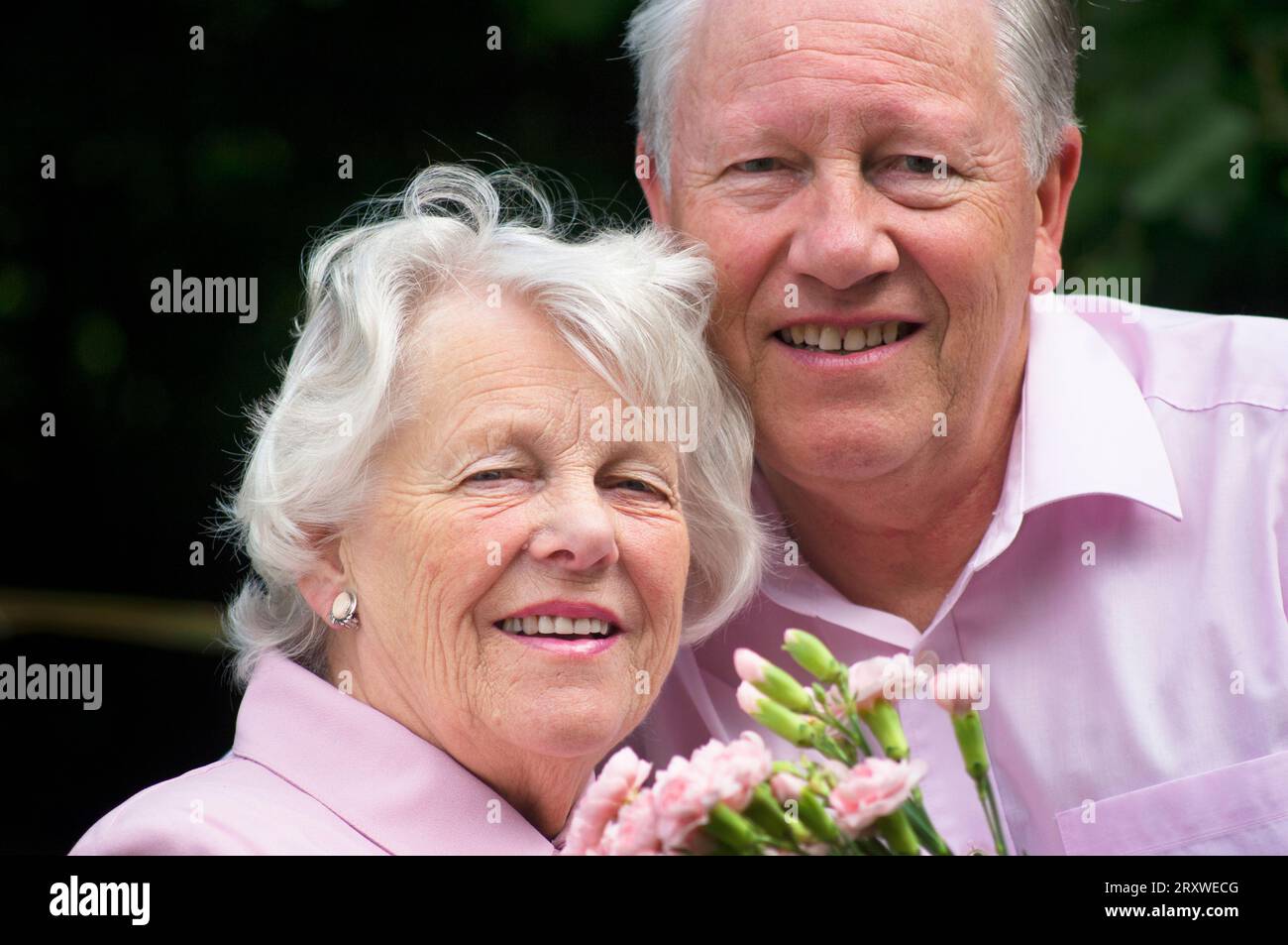 Heureux marié couple senior posant devant la caméra - John Gollop Banque D'Images