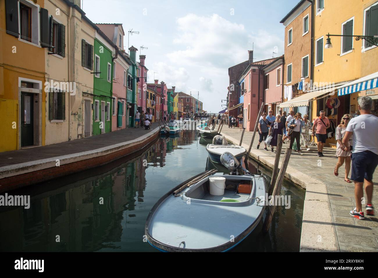 Burano, Vénétie, Italie, septembre 2023, scène de rue montrant des bateaux sur le canal et des maisons peintes colorées Banque D'Images