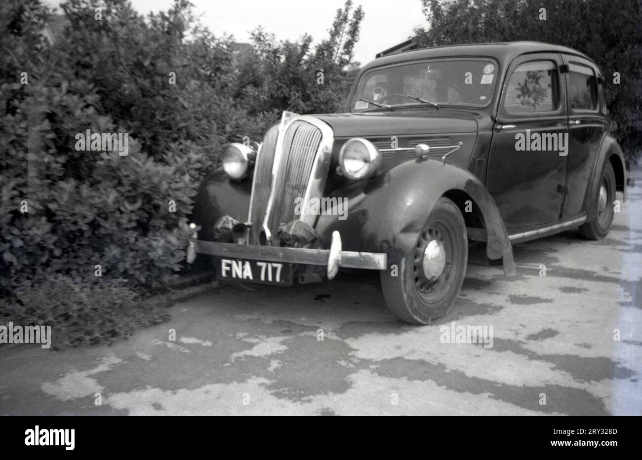 Années 1960, historique, voiture garée sur tarmac dans un camp de vacances, Angleterre, Royaume-Uni. Le véhicule a été fabriqué vers les années 1940 car il a des portes à charnières arrière. On parle également de portes de suicide, car si la voiture avance et qu'elle s'ouvre, quiconque saisit la porte pour l'arrêter risque d'être éjecté du véhicule, car les voitures fabriquées à cette époque ne sont pas équipées de ceintures de sécurité. Banque D'Images