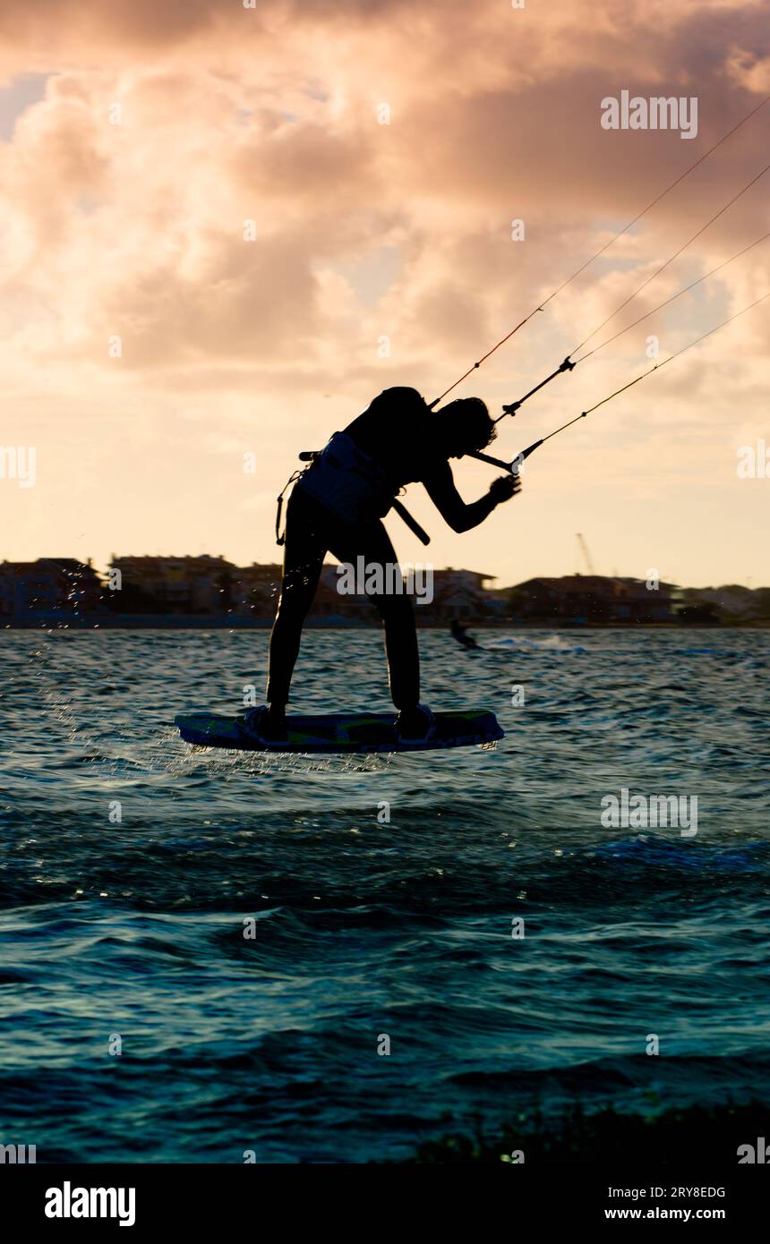 Silhouette d'un kitesurfer volant Banque D'Images