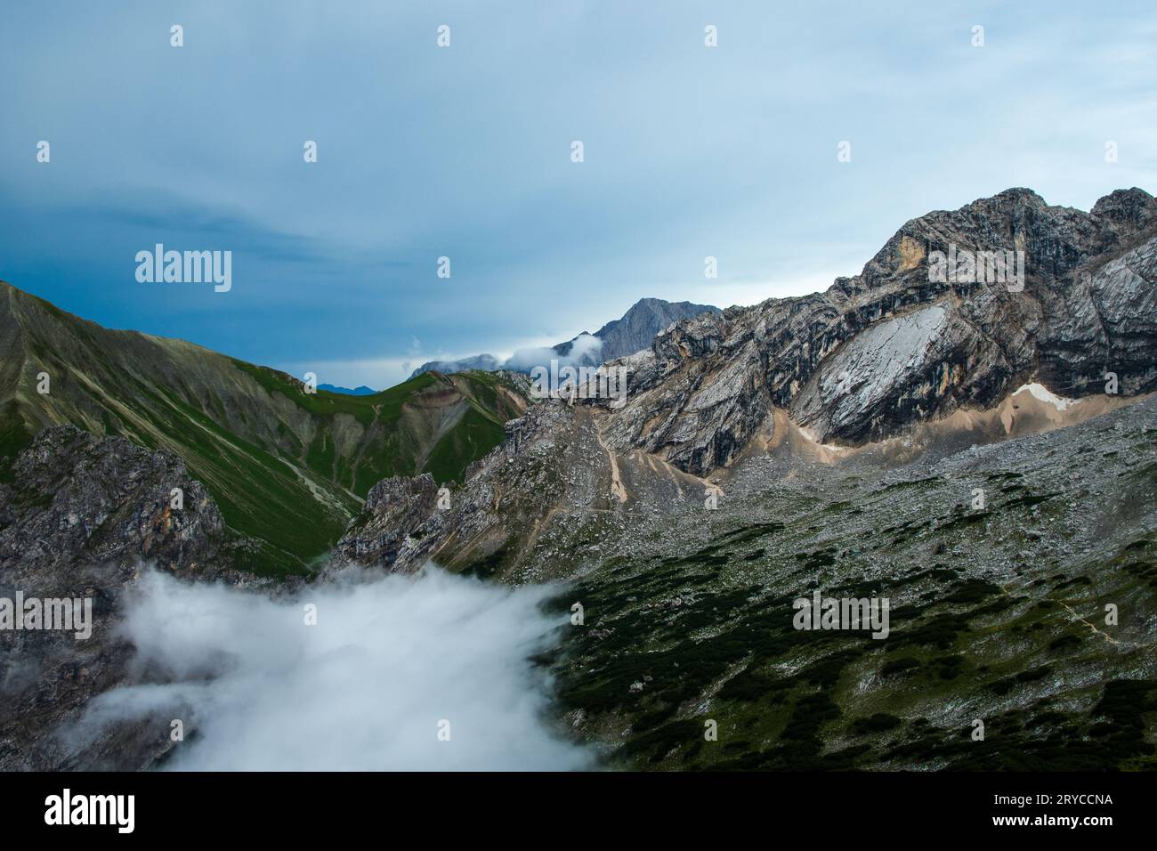 Nuages montants dans la vallée avec une vue panoramique sur les sommets de Gatterlkopf, Hochwand et Karkopf dans les montagnes de Wetterstein dans les Alpes Banque D'Images