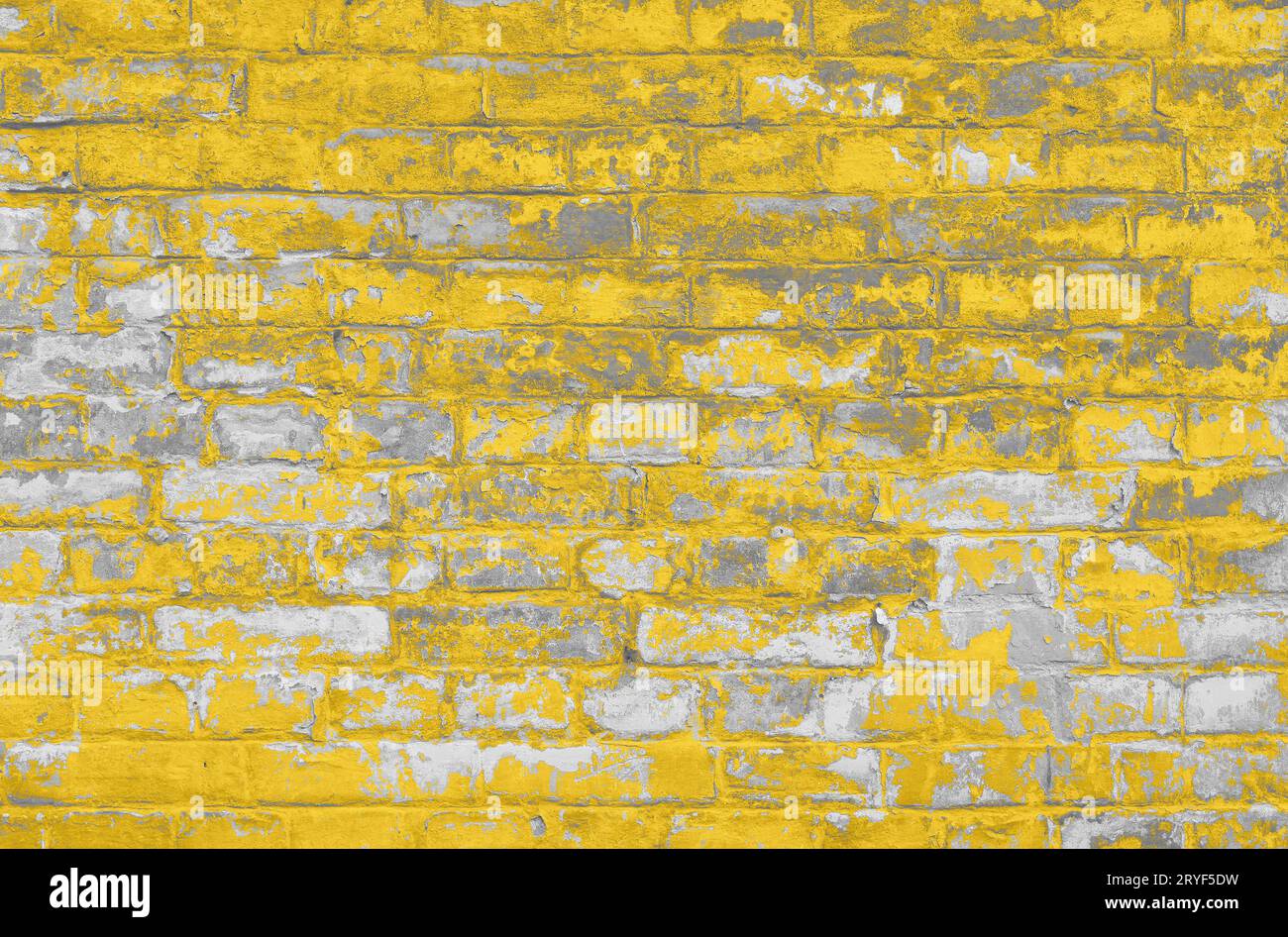 Mur de briques grises avec des flocons de peinture jaune Banque D'Images