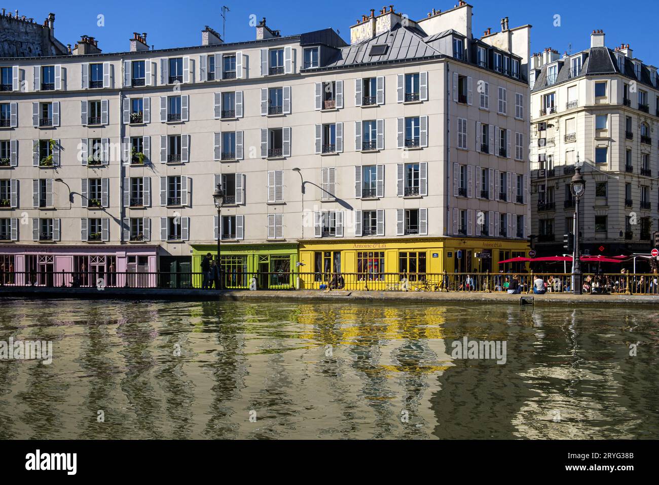 FRANCE. PARIS (75) QUARTIER XEME. CANAL SAINT-MARTIN. LES BÂTIMENTS DU QUAI DE VALMY ET LES FAÇADES COLORÉES DES MAGASINS ANTOINE ET LILI Banque D'Images