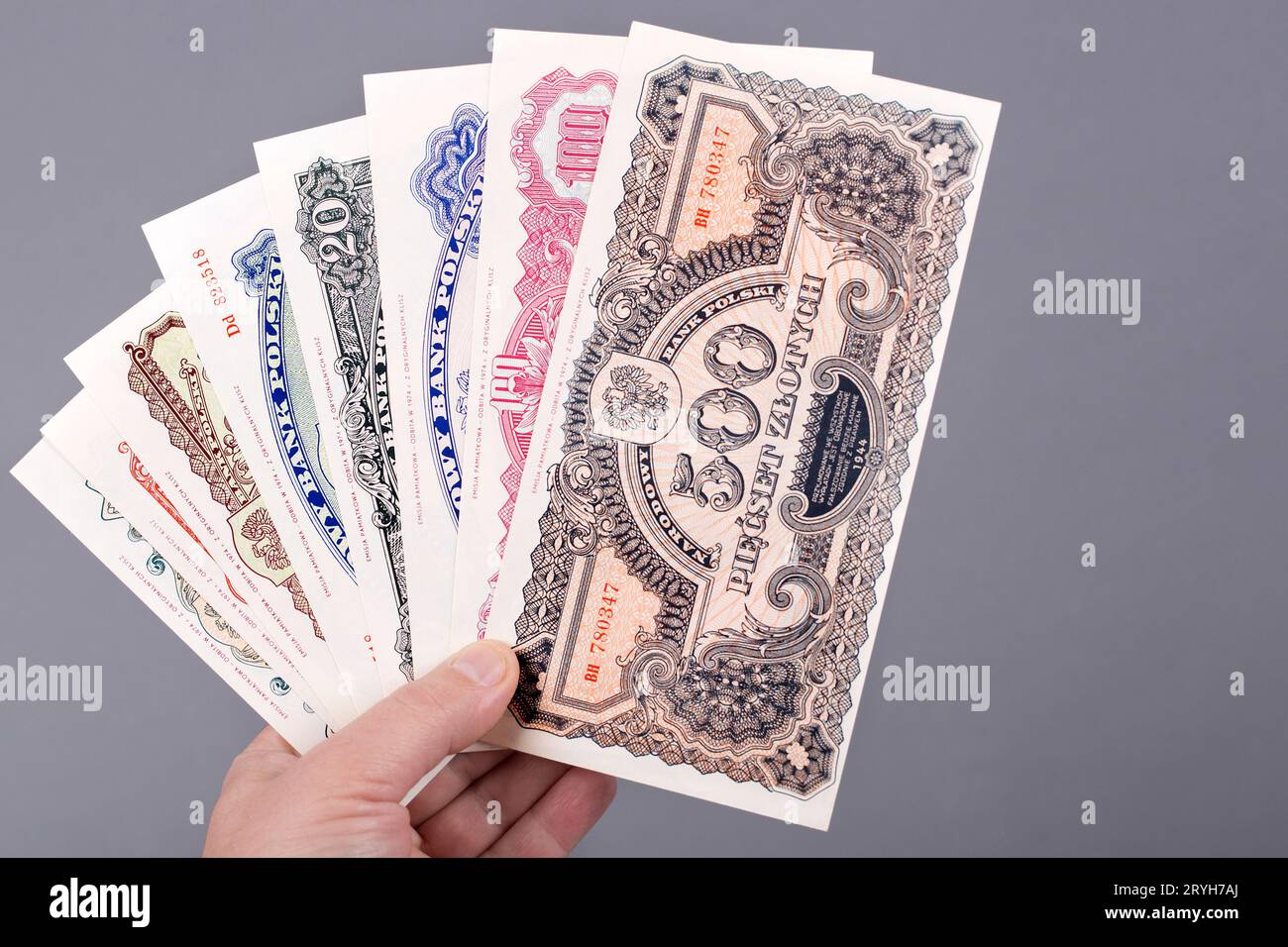 Vieux Zloty polonais dans la main sur un fond gris Banque D'Images