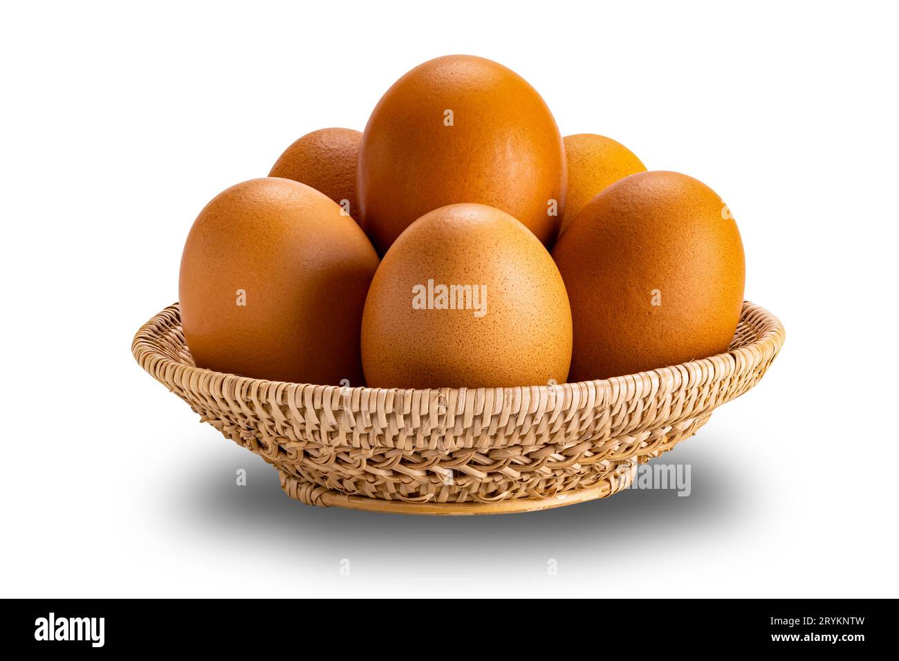 Groupe d'œufs de poule crus dans un panier en bambou isolé sur fond blanc. Banque D'Images