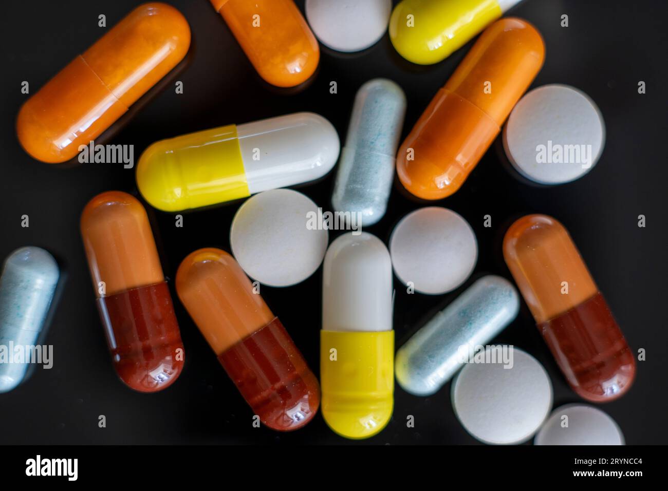 Pilules médicales, médicaments, suplements et vitamines sur fond noir Banque D'Images