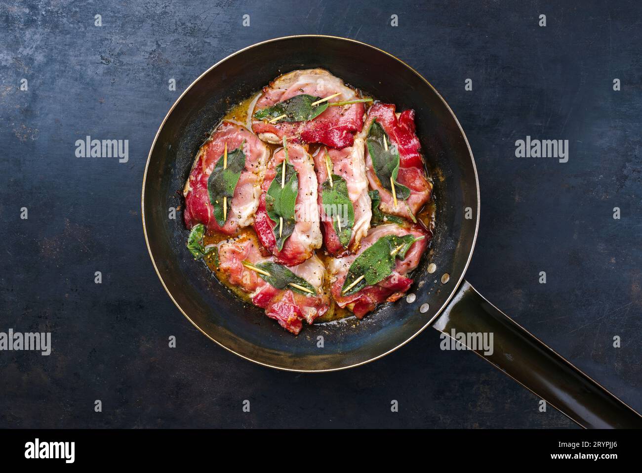 Saltimbocca alla Romana de porc frit italien traditionnel avec jambon de Parme et feuilles de sauge servi comme vue de dessus dans une poêle classique Banque D'Images