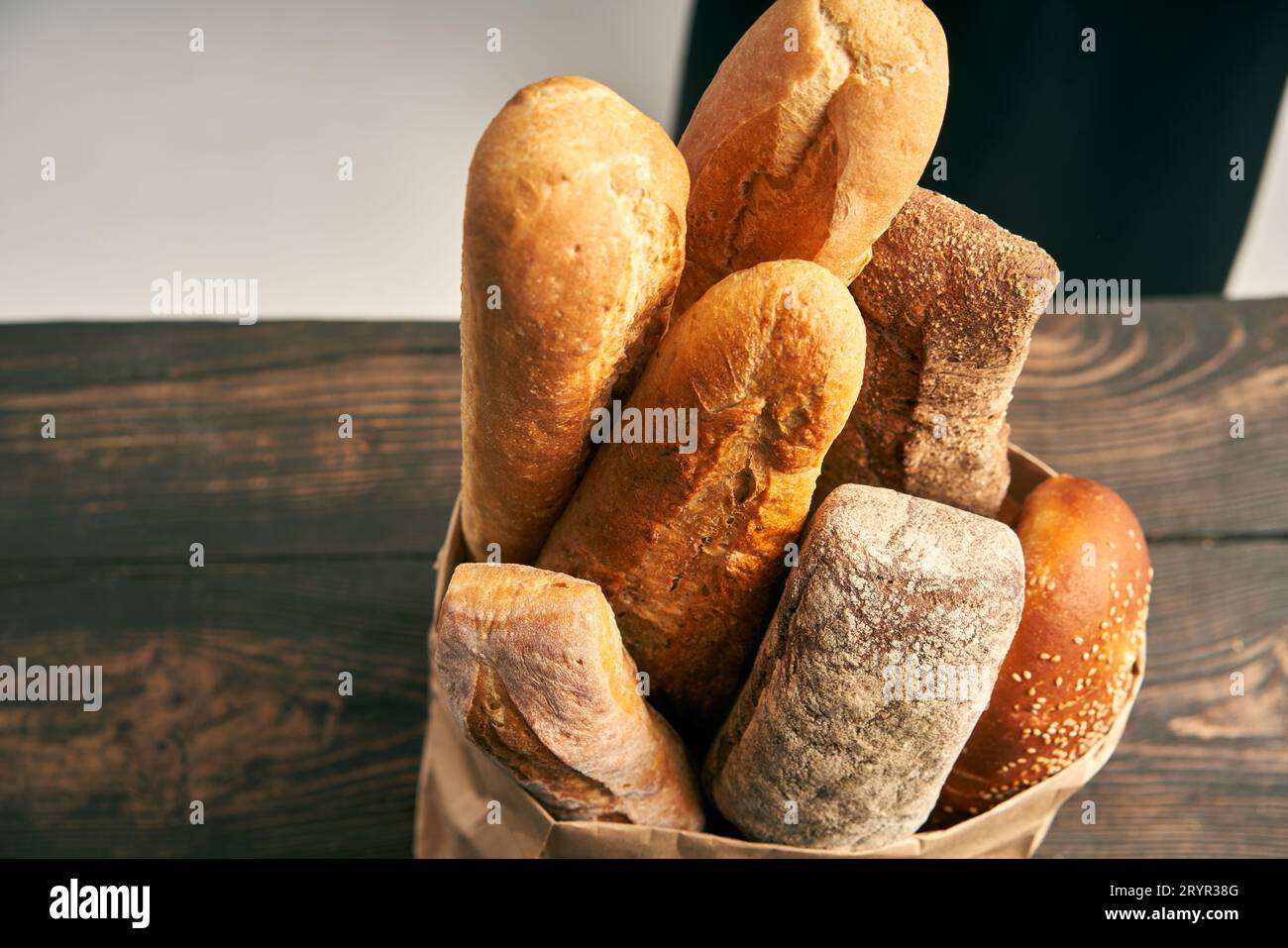 Vue de dessus de différents types de baguettes à pain français dans un sac en papier sur fond en bois Banque D'Images