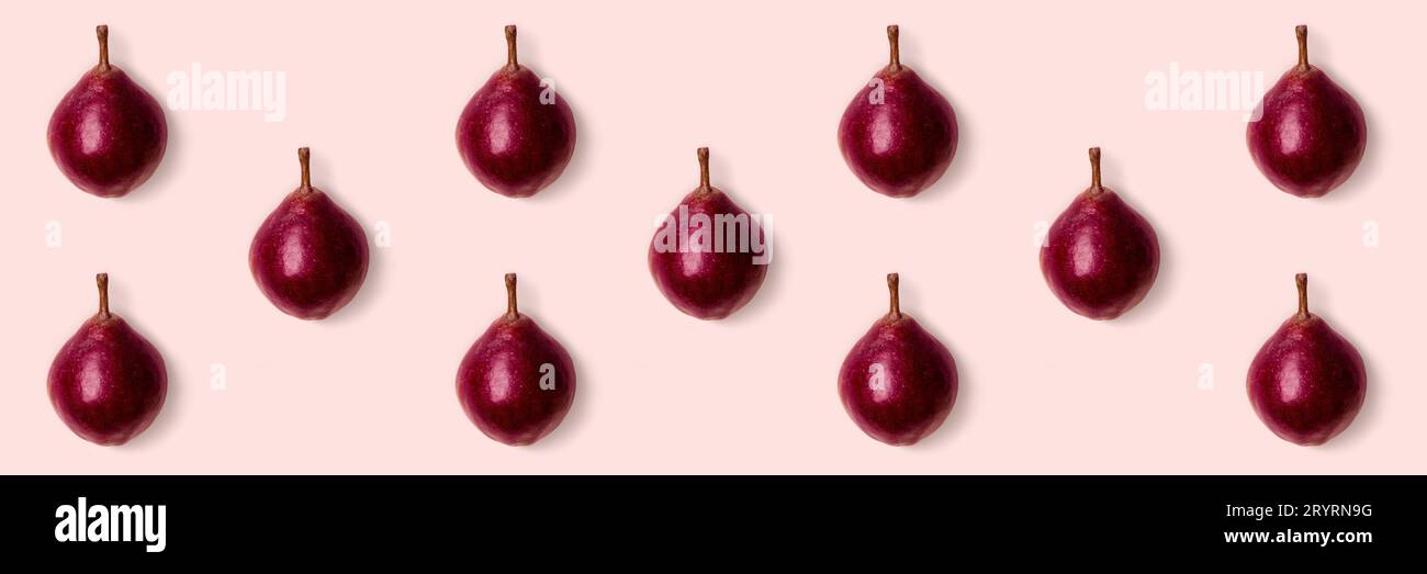 Poires violettes roses sur fond rose. Style minimaliste. Concept de récolte d'automne Banque D'Images
