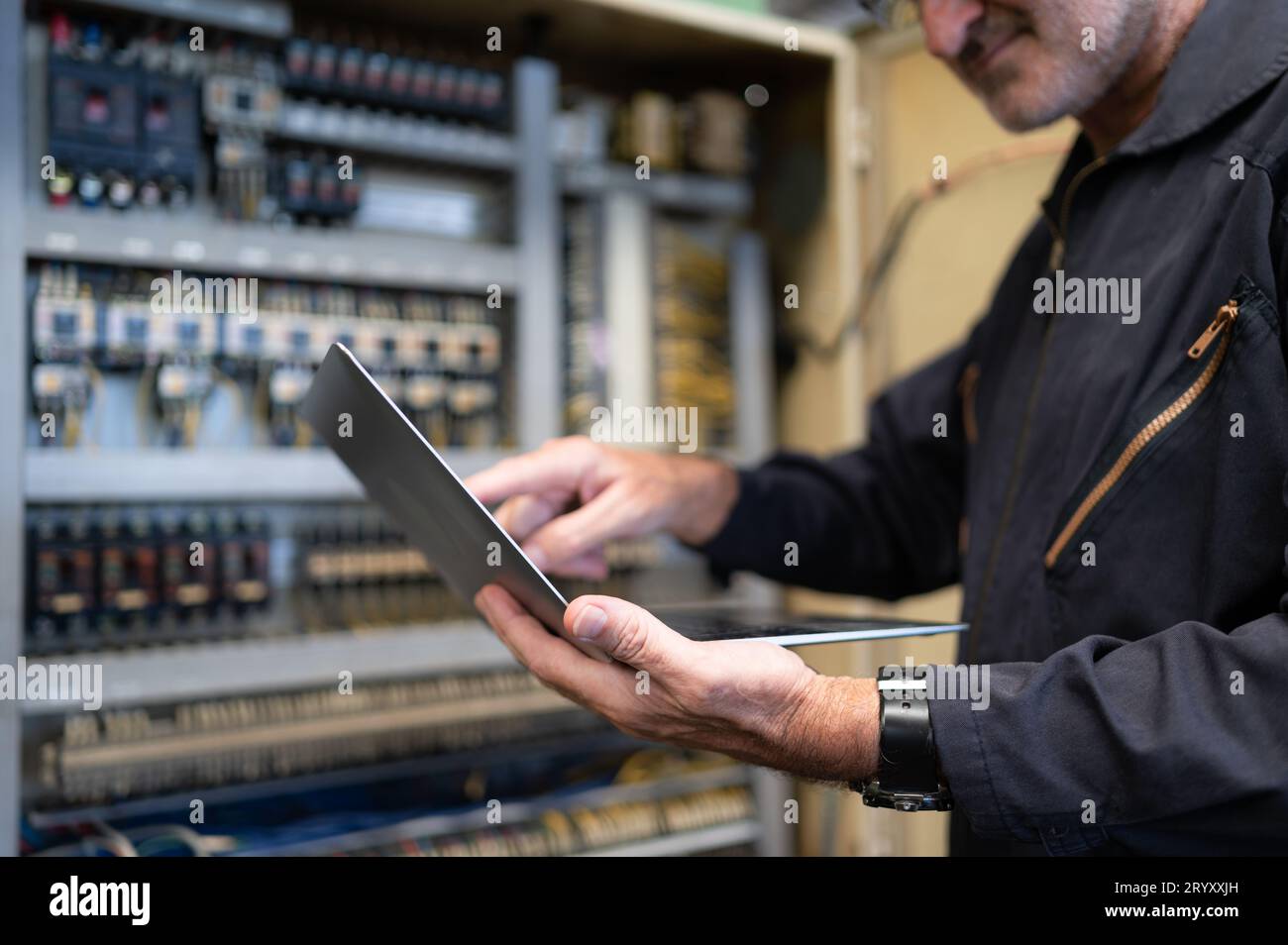 L'ingénieur principal inspecte le système électrique et répare le système mécanique dans l'armoire de commande de la machine. pour que th Banque D'Images