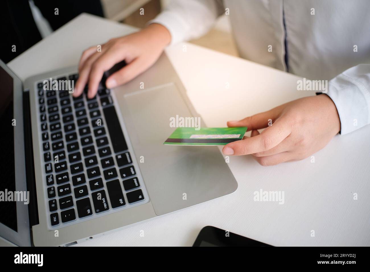 Femme magasinant sur un ordinateur portable tenant la carte de crédit pour Internet en ligne achats de commerce électronique dépenser de l'argent achats en ligne téléphone portable technologie con Banque D'Images