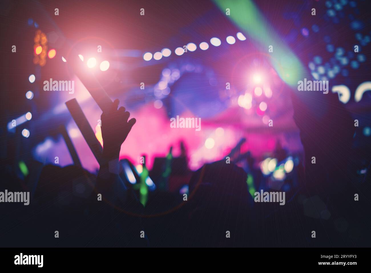 Silhouettes de personnes de foule en concert lumières de scène lumineuses. Film de ton rose vert et violet. Silhouette des mains. People et Ent Banque D'Images