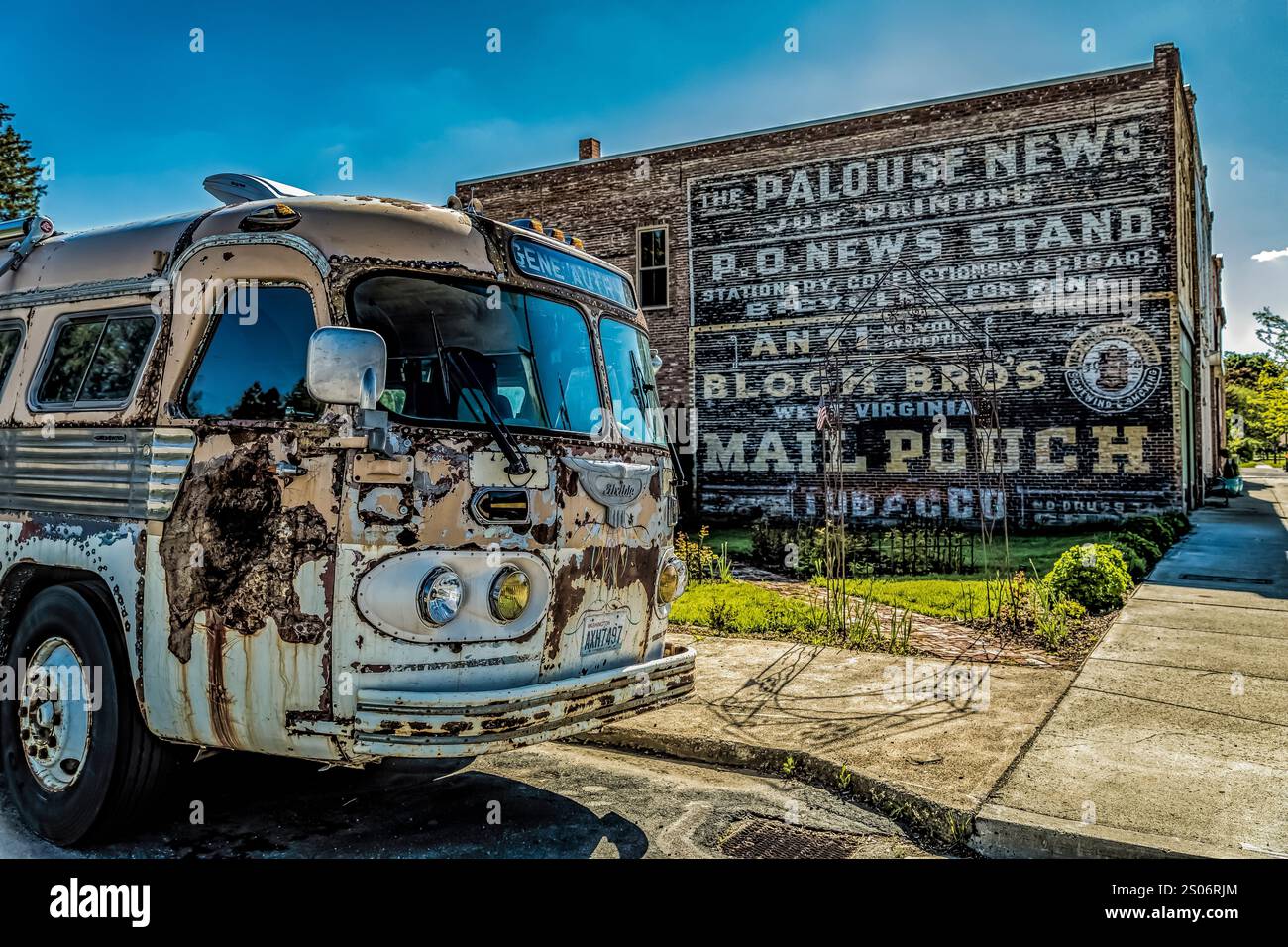 Vieux bus avec panneau fantôme sur un mur de briques dans le village de Palouse, État de Washington, États-Unis [pas de publication ; licence éditoriale uniquement] Banque D'Images