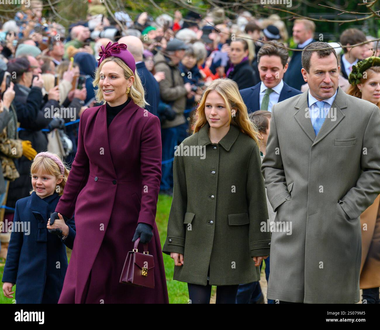 Sandringham, Norfolk, Royaume-Uni. 25 décembre 2024. Lena Tindall tient la main de sa mère, Zara Tindall, alors qu'ils rejoignent le reste de la famille royale dans leur promenade traditionnelle à l'église Mary Magdalene sur le domaine Sandringham pour le service du matin de Noël. Peter Phillips et sa fille Isla sont également sur la photo. Crédit : MartinJPalmer/Alamy Live Newsmatching Banque D'Images