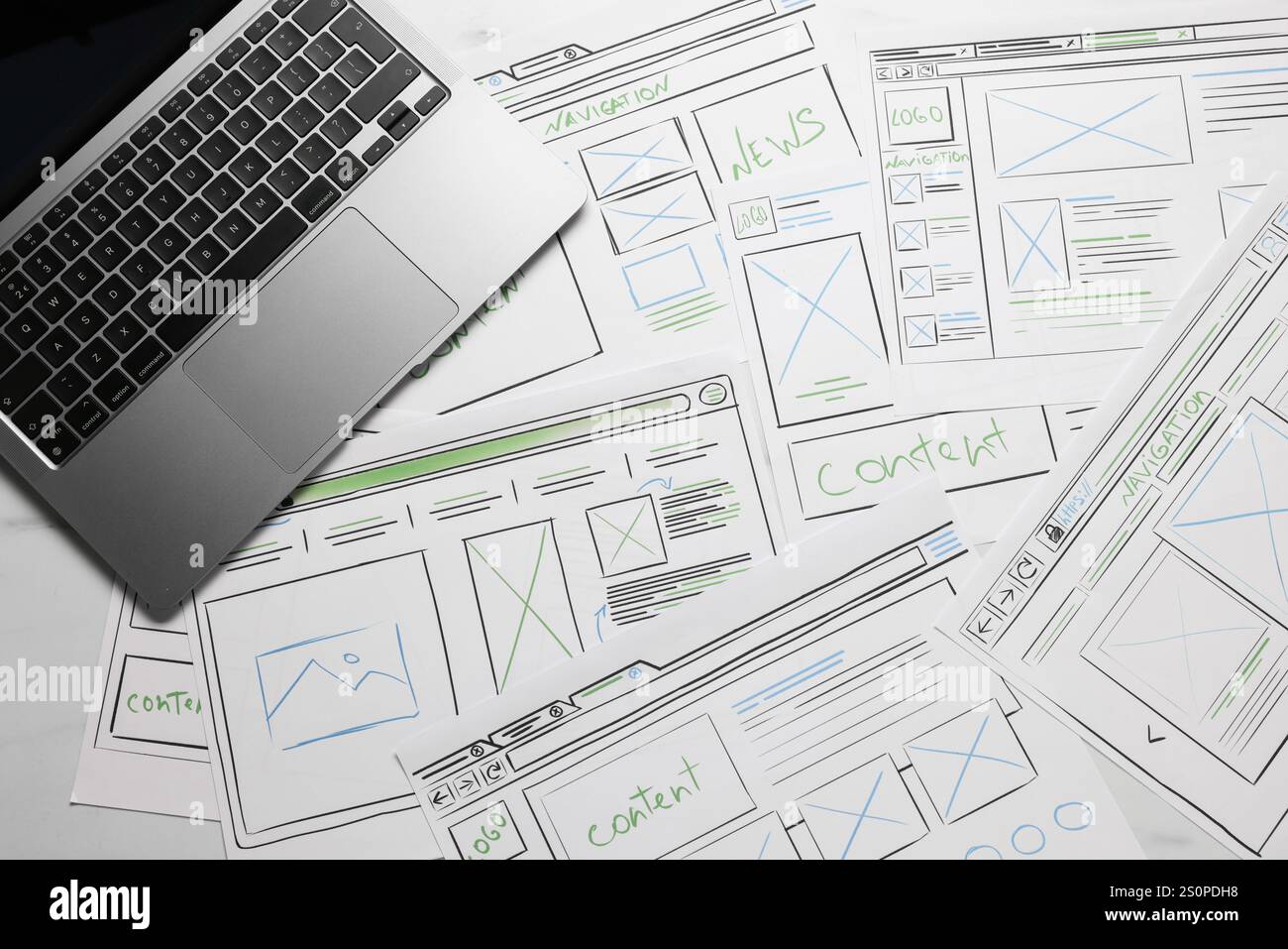 Développement de la conception de l'interface utilisateur. Croquis de wireframes de site Web et ordinateur portable sur la table, vue de dessus Banque D'Images