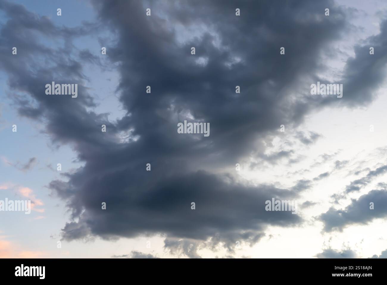 Vue à angle bas du ciel sombre avec une forme étrange de nuages noirs moelleux le matin ou le soir tandis que le coucher du soleil ou le lever du soleil est utilisé comme fond naturel t Banque D'Images