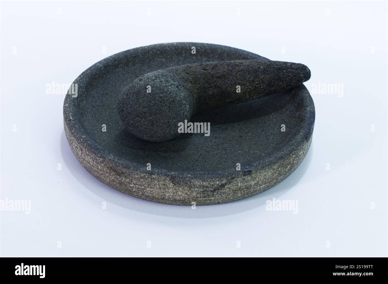 Mortier de pierre traditionnel et pilon pour la préparation des aliments sur un fond blanc Banque D'Images