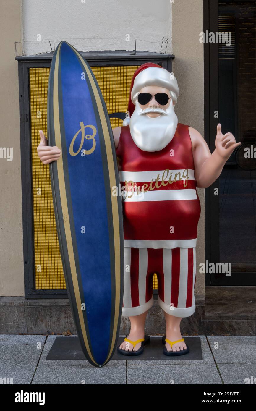 Surfin Santa à l'entrée d'un magasin Breitling à Stuttgart, Allemagne. Figur Surfing Santa im Eingangsbereich einer Breitling filiale Stuttgart Banque D'Images