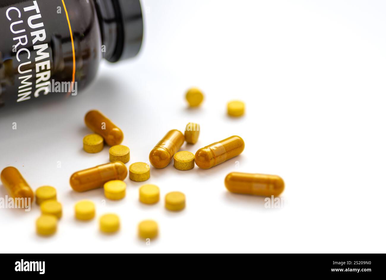 Suppléments de santé en comprimés de curcumine curcuma isolés sur blanc. Banque D'Images
