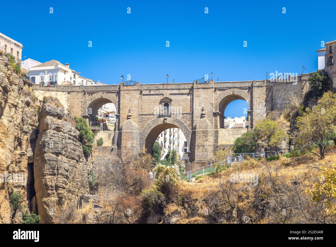 Le pont Puente Nuevo dans la gorge El Tajo dans la ville de Ronda en Espagne. Ancien pont de pierre enjambant une gorge profonde, avec des bâtiments visibles de chaque côté und Banque D'Images