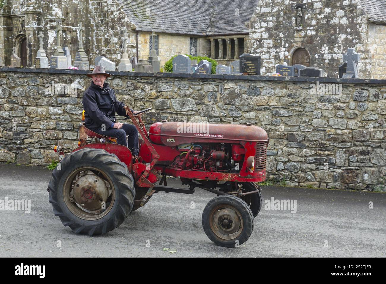 Ancien tracteur Massey Ferguson devant l'église et la chapelle Sainte nonne, voiture ancienne rencontre Dirinon, département Finistère Penn Ar Bed, région Bretagne Banque D'Images