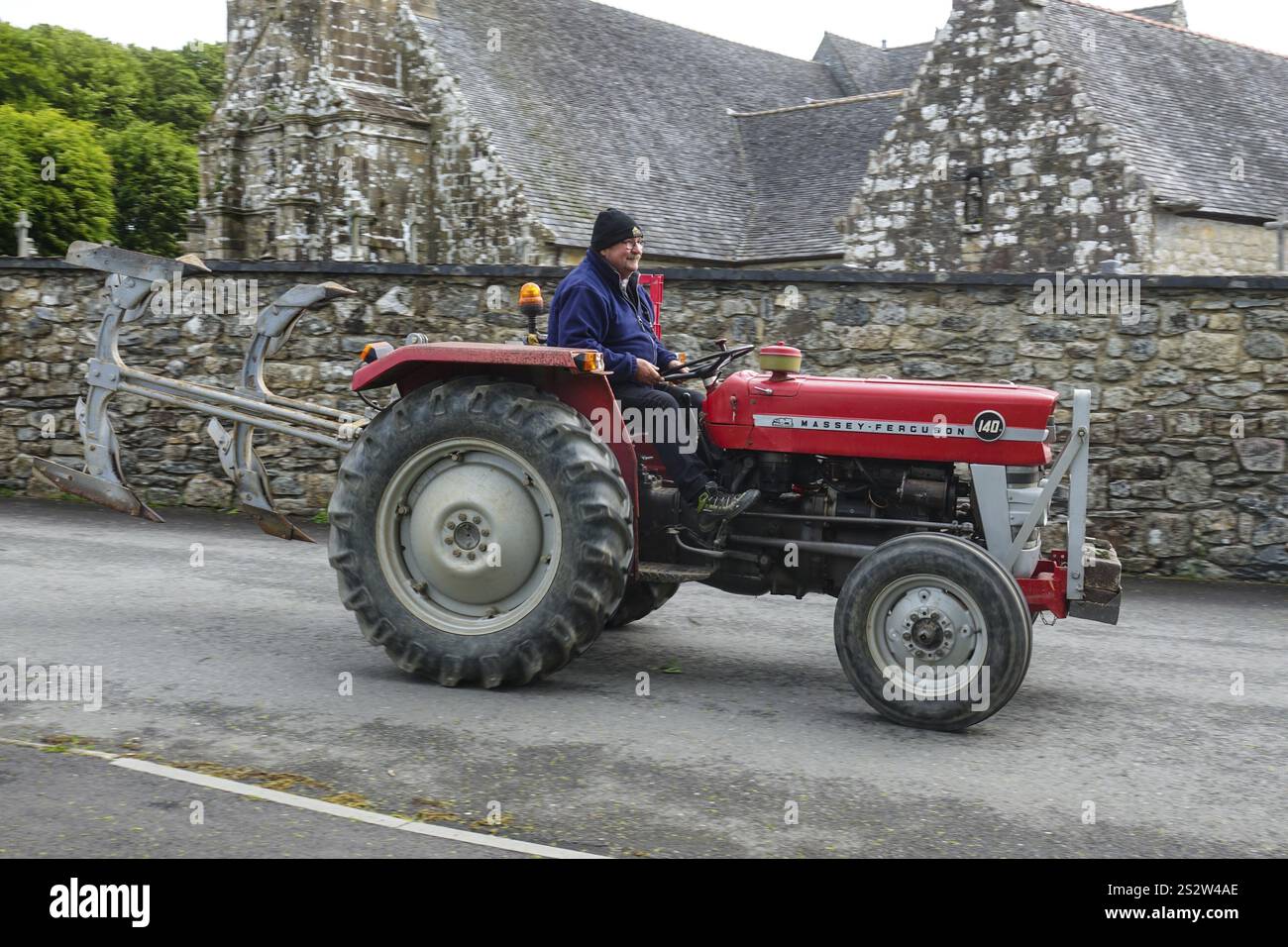 Ancien tracteur Massey Ferguson 140 devant l'église et la chapelle Sainte nonne, voiture ancienne rencontre Dirinon, département Finistère Penn Ar Bed, région Bret Banque D'Images