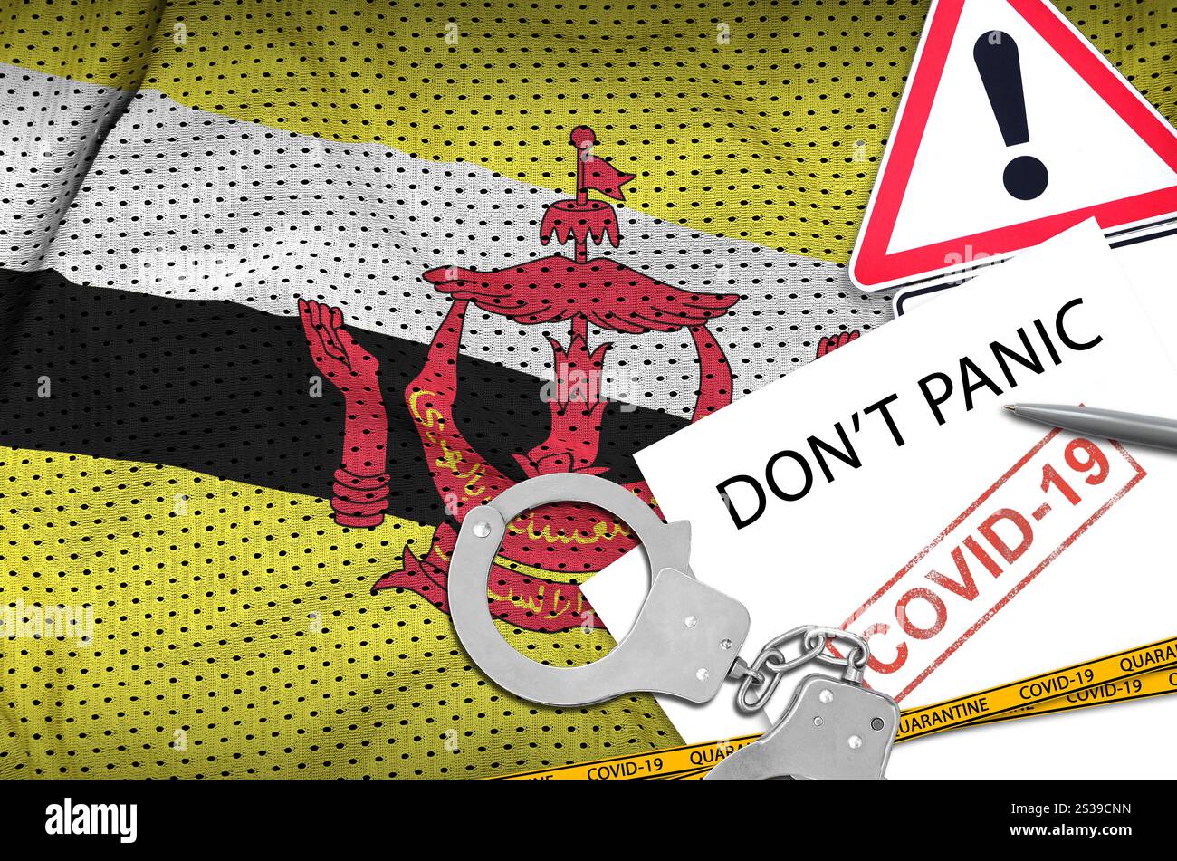 Drapeau du Brunei Darussalam et menottes de police avec inscription ne paniquez pas sur papier blanc. Concept de coronavirus ou virus pandémique 2019-nCoV. Brunei Banque D'Images