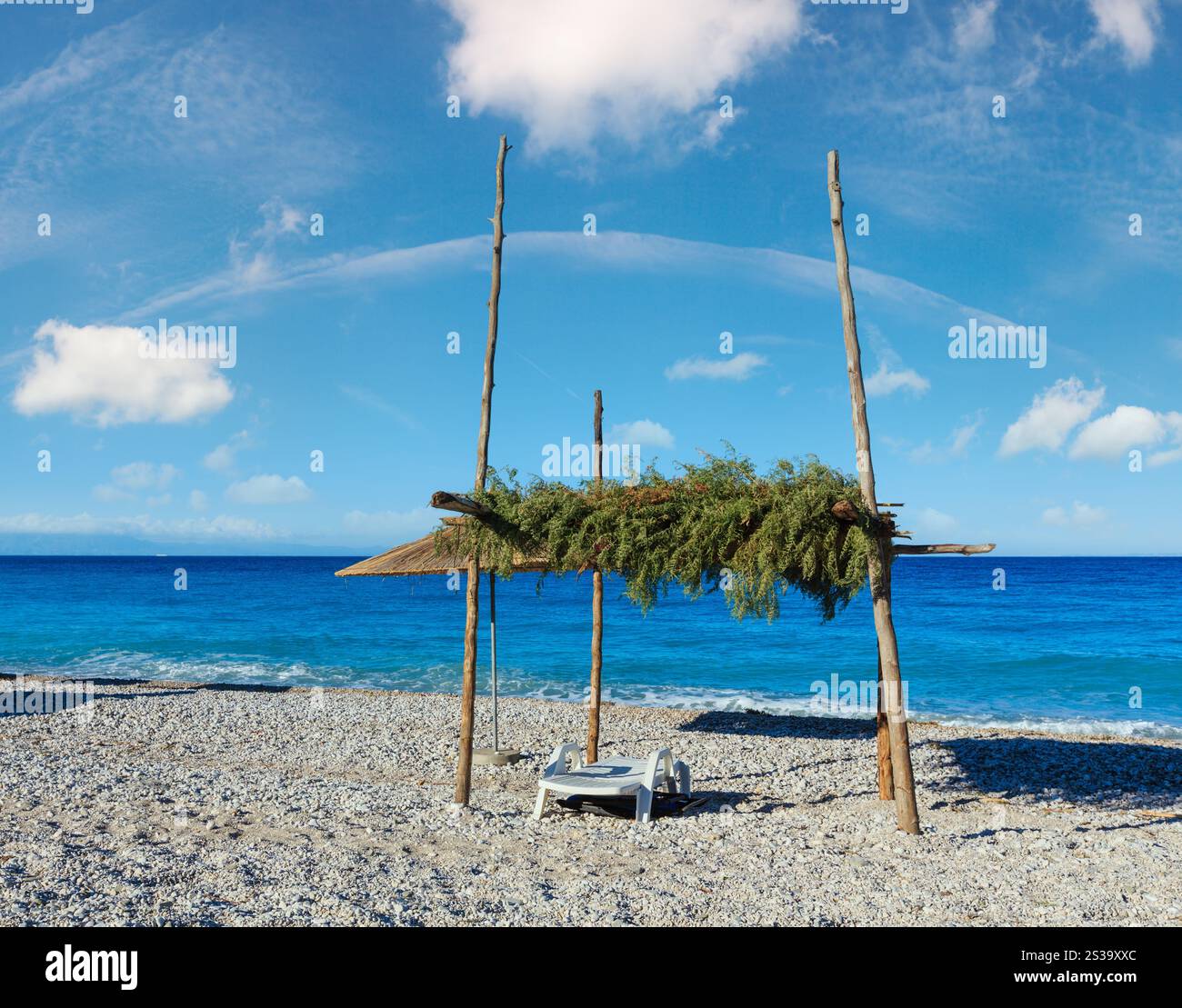 Matin d'été plage de galets avec transats et couvert (Albanie). Banque D'Images