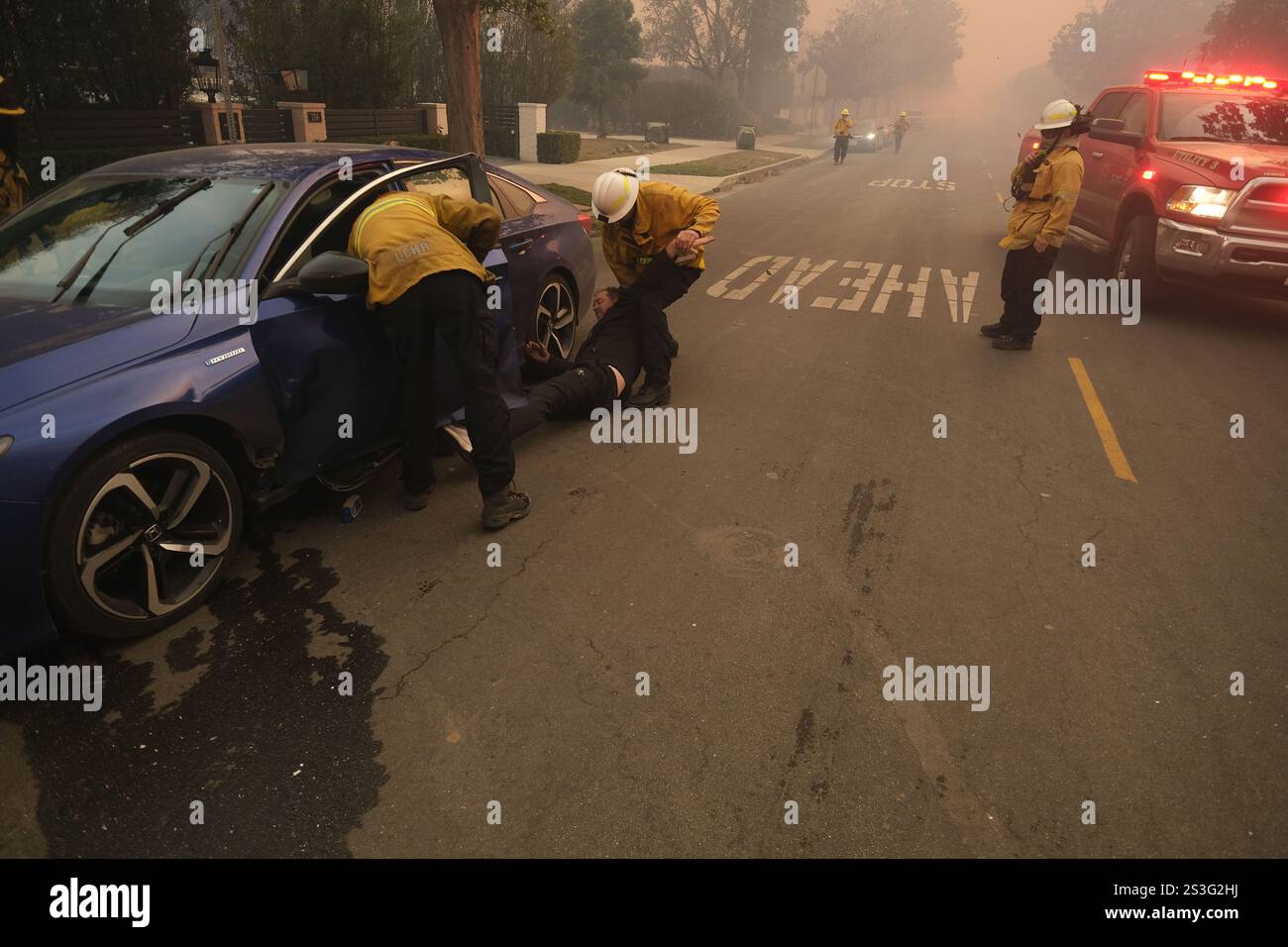Pacific Palisades, Californie, États-Unis. 9 janvier 2025. un résident retenu par un pompier alors qu'il était désemparé et ivre. Il a brisé les lignes de police avec sa voiture et a regardé sa maison brûler alors que les pompiers l'éteignaient sans succès. Les pompiers ont continué à combattre quotidiennement l'incendie intense de Pacific Palisades, Californie avec des vents élevés de Santa Ana atteignant jusqu'à 85 miles à l'heure. Cinq feux de forêt majeurs faisant rage dans le comté de Los Angeles, le comté le plus peuplé des États-Unis, ont tué au moins 5 personnes et forcé des dizaines de milliers de résidents à être évacués. (Crédit IM Banque D'Images